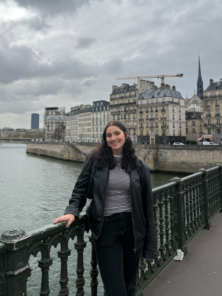 francesca on a bridge in Paris with city behind